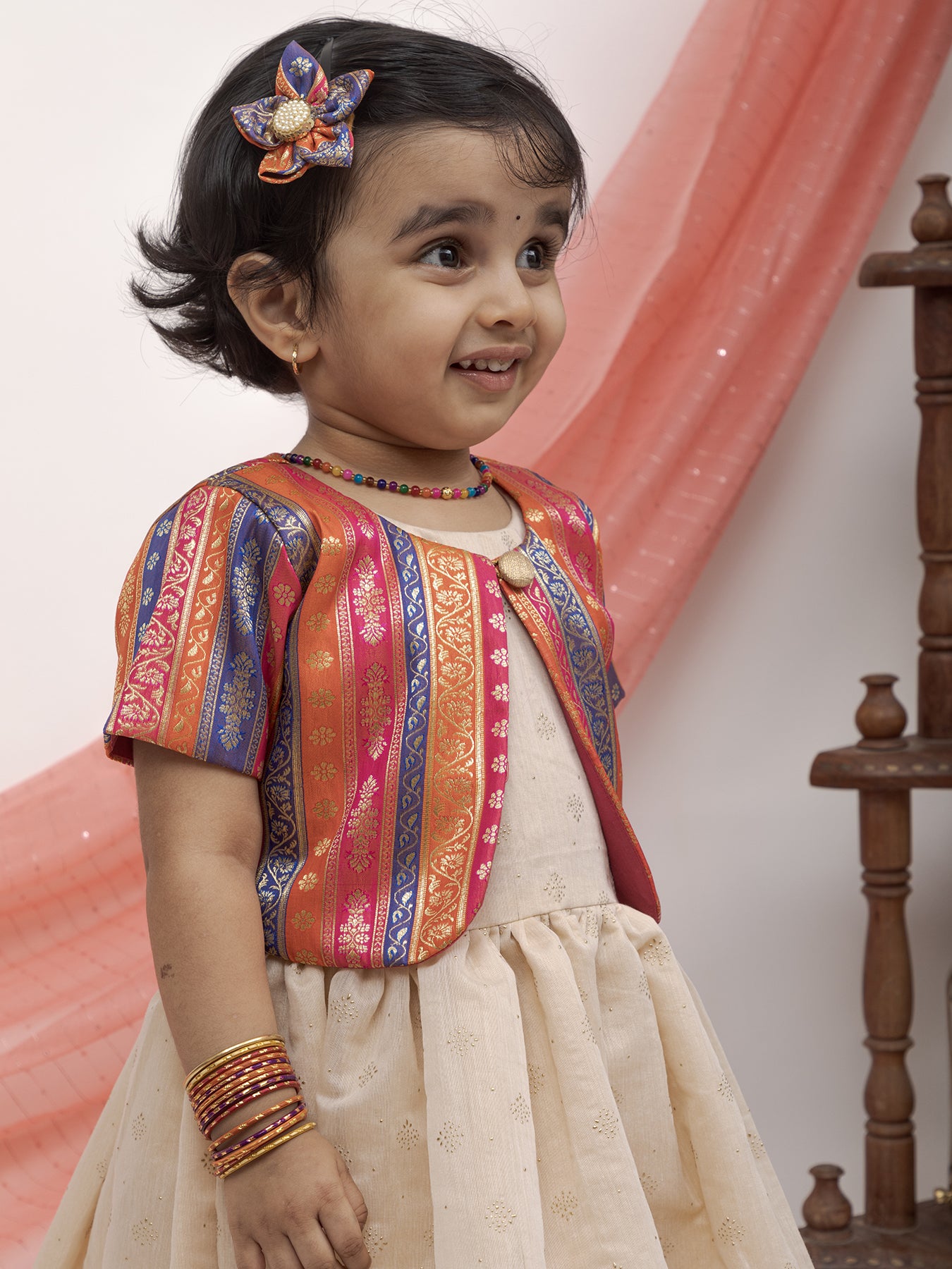 Ivory foil printed Chanderi Frock with banaras silk jacket for Girl.Let your princess be as comfortable as in her casuals with carefully designed & crafted Comfort Ethnic Wear by Soyara Ethnics.Keep her fashion quotient high with timeless patterns, vibrant combinations and royal textiles.