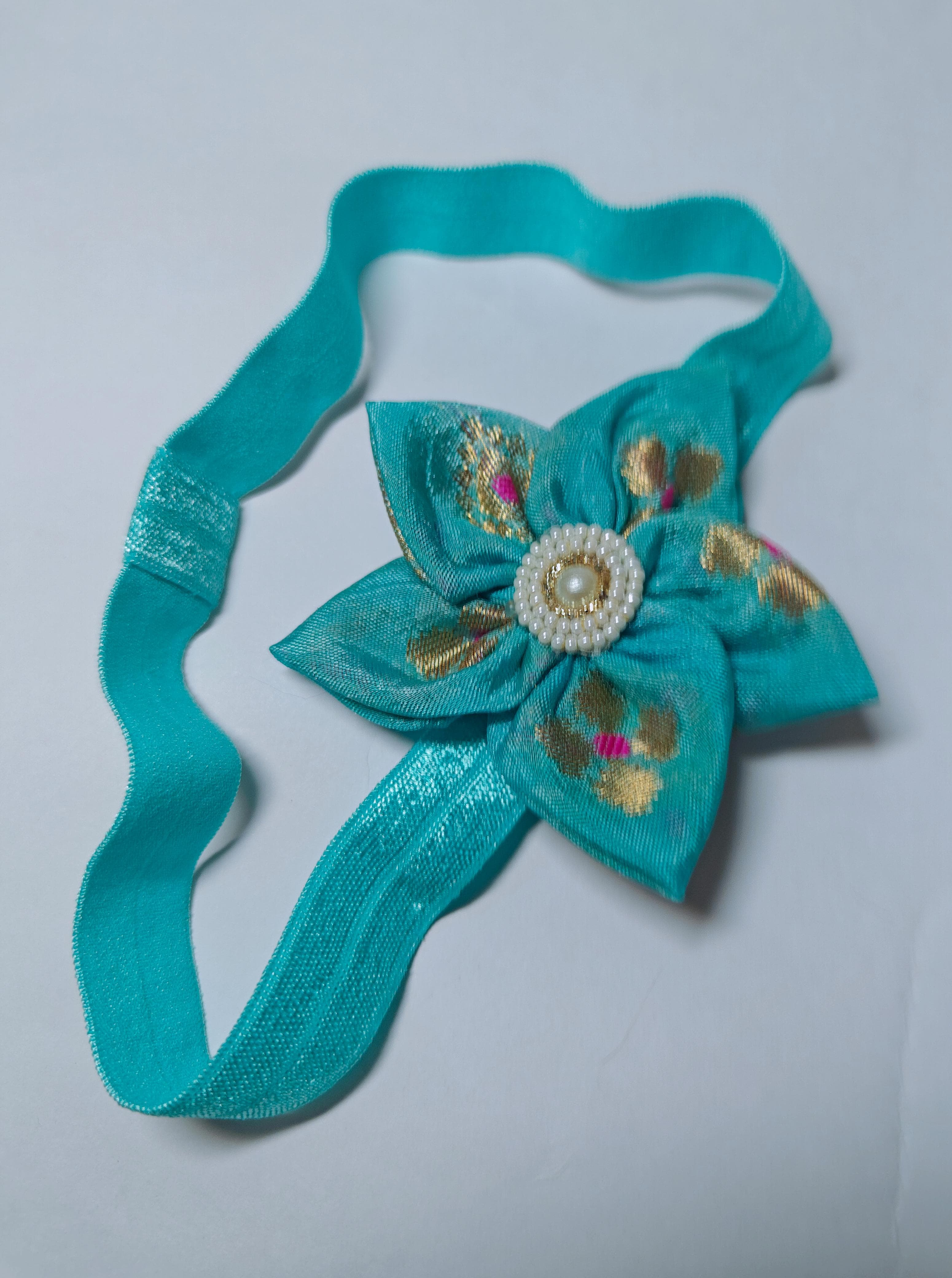Cool Coloured Sadafuli Flower Stretchable headband for baby girl.Adorn your princess with head to toe premium quality handcrafted accessories made from allergy free, best quality materials.