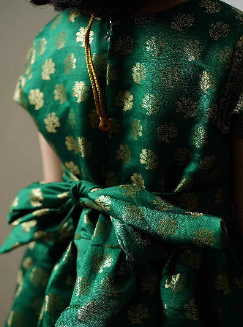 Leaf Green banarasi brocade dress with woven jari borders for Girls.Let your princess be as comfortable as in her casuals with carefully designed & crafted Comfort Ethnic Wear by Soyara Ethnics.Keep her fashion quotient high with timeless patterns, vibrant combinations and royal textiles.