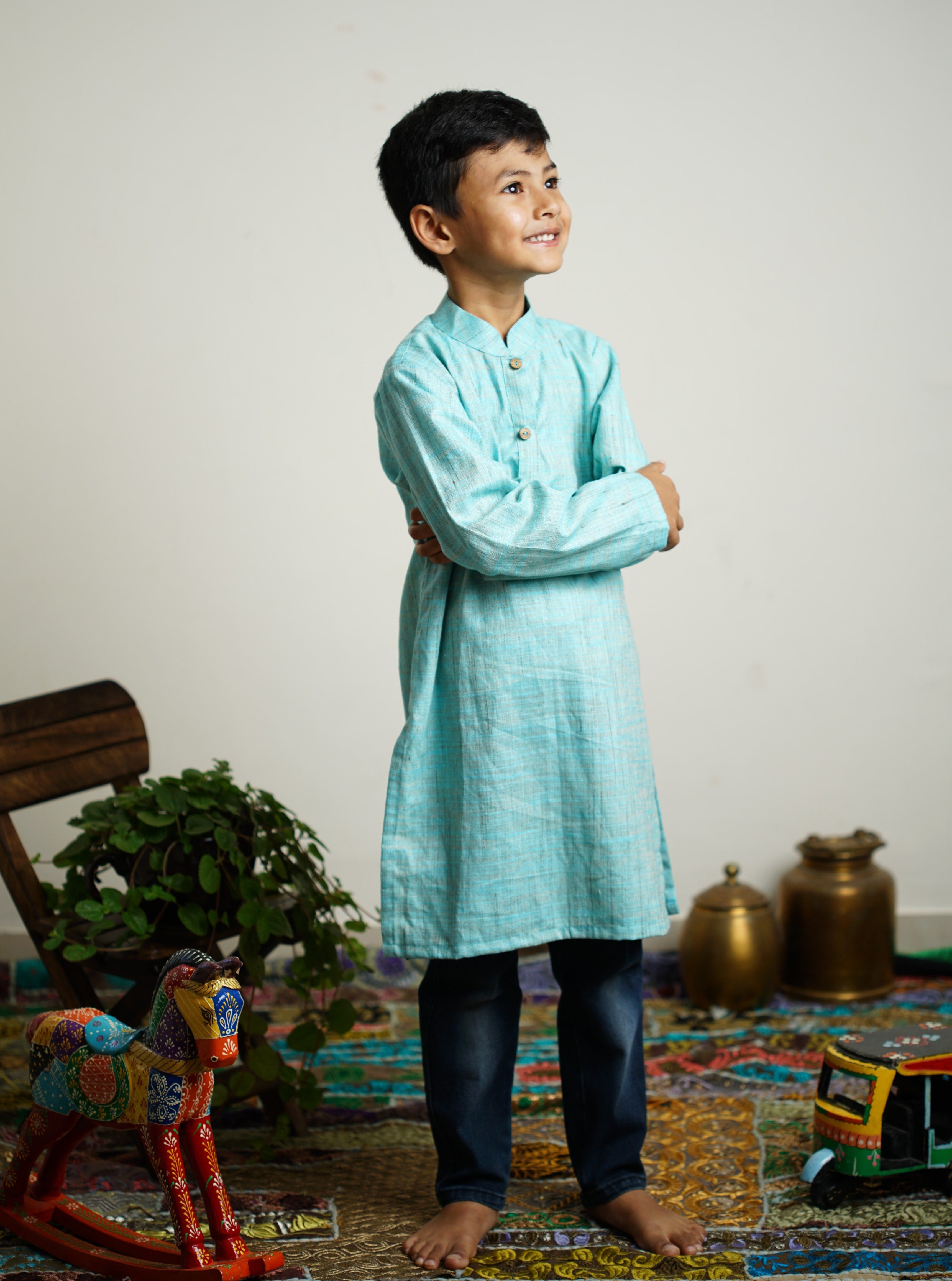 Sky Blue Khadi silk stand collar long kurta with wooden buttons.Kurtas with collar or Angrakha pattern teamed with salwar are the best choice for any festive occasion for boys.They are Trendy, Easy to wear and comfortable to carry.