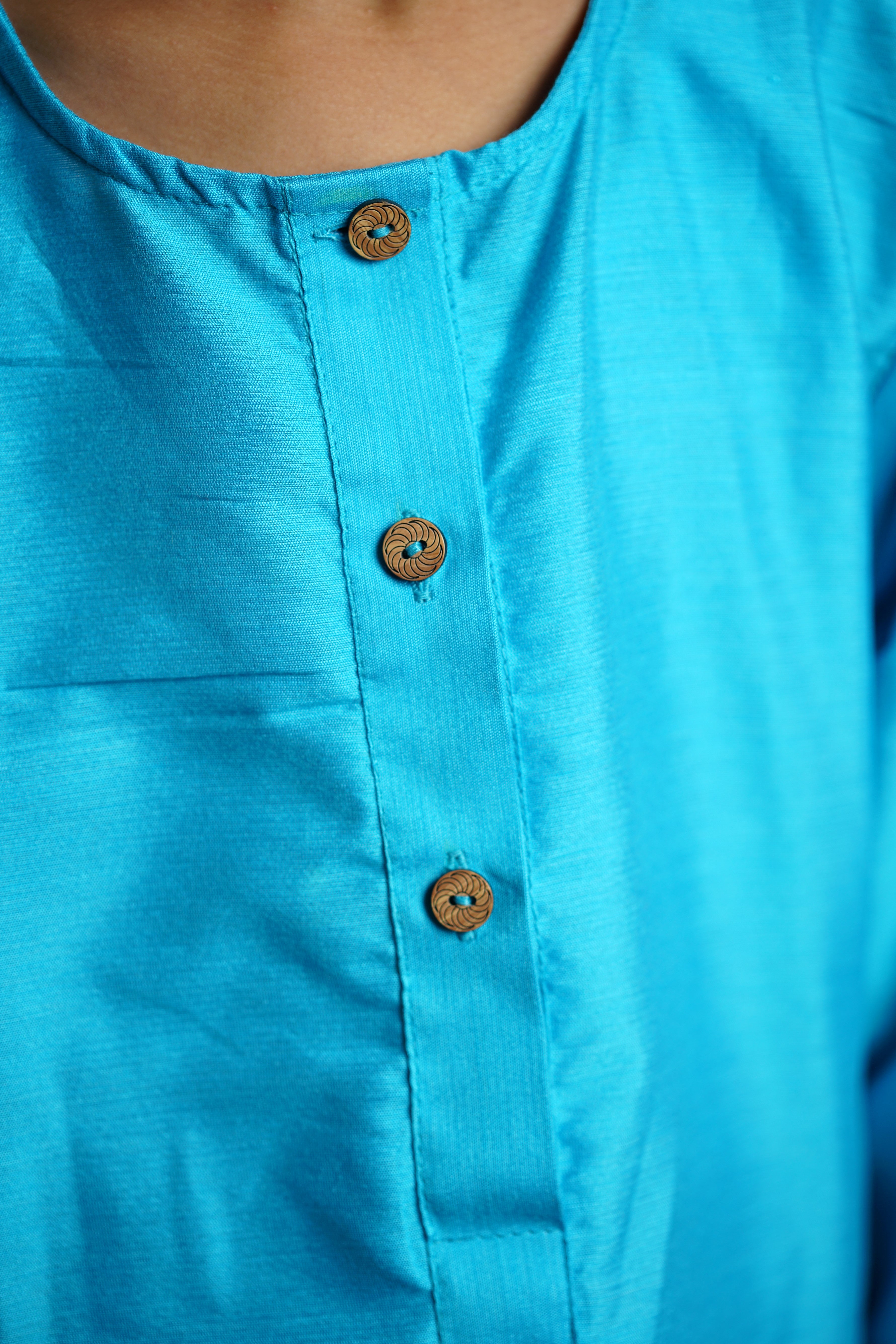 Sky Blue cotton silk Round neck long kurta with wooden buttons.Kurtas with collar or Angrakha pattern teamed with salwar are the best choice for any festive occasion for boys.They are Trendy, Easy to wear and comfortable to carry.