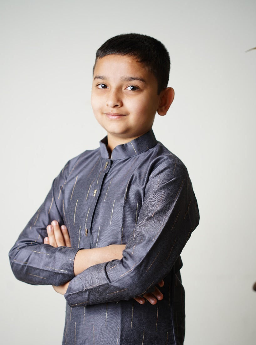 Slate grey pine silk Kurta with interesting jari stripes.Kurtas with collar or Angrakha pattern teamed with salwar are the best choice for any festive occasion for boys.They are Trendy, Easy to wear and comfortable to carry.