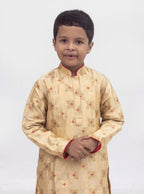 Beige banarasi brocade kurta set with a highlighted stand collar and front placket and red cotton silk chunidar salwar for Boys.Kurtas with collar or Angrakha pattern teamed with salwar are the best choice for any festive occasion for boys. They are Trendy, Easy to wear and comfortable to carry.