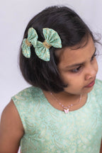 Introducing our latest product: a stunning Pista Green banarasi brocade yoke paired with a Rose Pink raw silk pleated dress, complete with a delicate sequined lace waist detailing, designed specifically for girls. With its intricate craftsmanship and elegant color combination, this dress is sure to make a statement. Don't miss out on this unique addition to our collection!