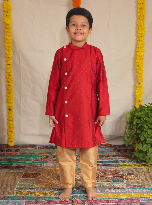 Deep red pine silk Bandh gala kurta with side placket and golden cotton silk salwar set.Kurtas with collar or Angrakha pattern teamed with salwar are the best choice for any festive occasion for boys. They are Trendy, Easy to wear and comfortable to carry.