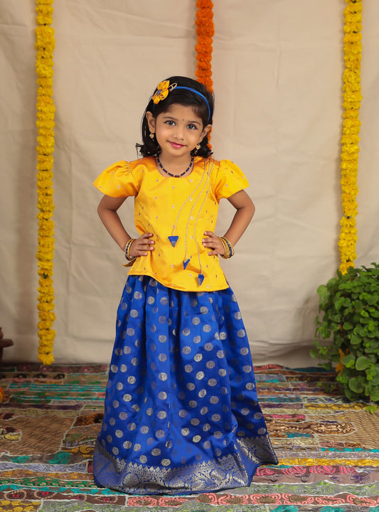 Royal Blue Banaras brocade parkar with intricate woven Border teamed with Yellow brocade Polka.Let your princess be as comfortable as in her casuals with carefully designed & crafted Comfort Ethnic Wear by Soyara Ethnics.Keep her fashion quotient high with timeless patterns, vibrant combinations and royal textiles.