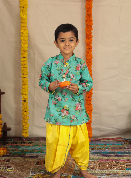Cyan floral printed stand collar kurta with yellow cotton silk dhoti with floral printed piping detailing.Kurtas with collar or Angrakha pattern teamed with salwar are the best choice for any festive occasion for boys. They are Trendy, Easy to wear and comfortable to carry.