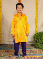Mango coloured raw silk kurta and Purple cotton silk salwar set.Kurtas with collar or Angrakha pattern teamed with salwar are the best choice for any festive occasion for boys. They are Trendy, Easy to wear and comfortable to carry.