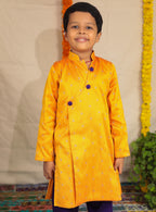 Mango coloured raw silk kurta and Purple cotton silk salwar set.Kurtas with collar or Angrakha pattern teamed with salwar are the best choice for any festive occasion for boys. They are Trendy, Easy to wear and comfortable to carry.