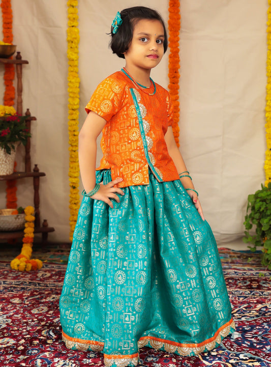 Teal brocade parkar orange highlight teamed with orange brocade overlap pattern polka.Let your princess be as comfortable as in her casuals with carefully designed & crafted Comfort Ethnic Wear by Soyara Ethnics.Keep her fashion quotient high with timeless patterns, vibrant combinations and royal textiles.