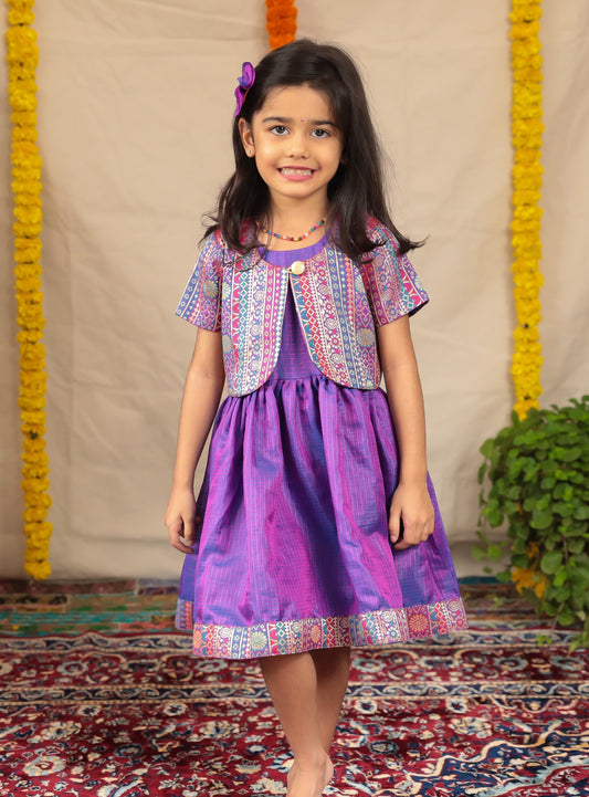 Purple Chanderi Kotta Silk Frock with Banaras silk jacket for girl.Let your princess be as comfortable as in her casuals with carefully designed & crafted Comfort Ethnic Wear by Soyara Ethnics.Keep her fashion quotient high with timeless patterns, vibrant combinations and royal textiles.