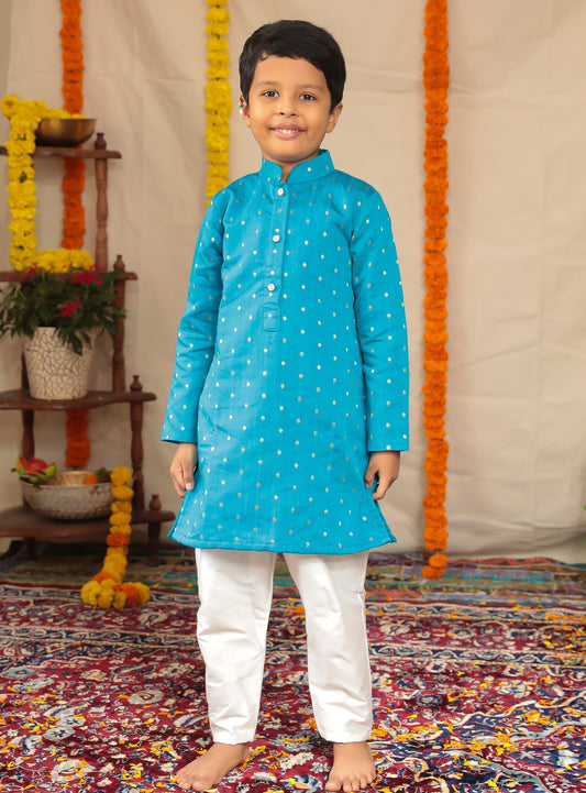 Teal blue Pine silk stand collar kurta with white cotton silk salwar set.Kurtas with collar or Angrakha pattern teamed with salwar are the best choice for any festive occasion for boys. They are Trendy, Easy to wear and comfortable to carry.