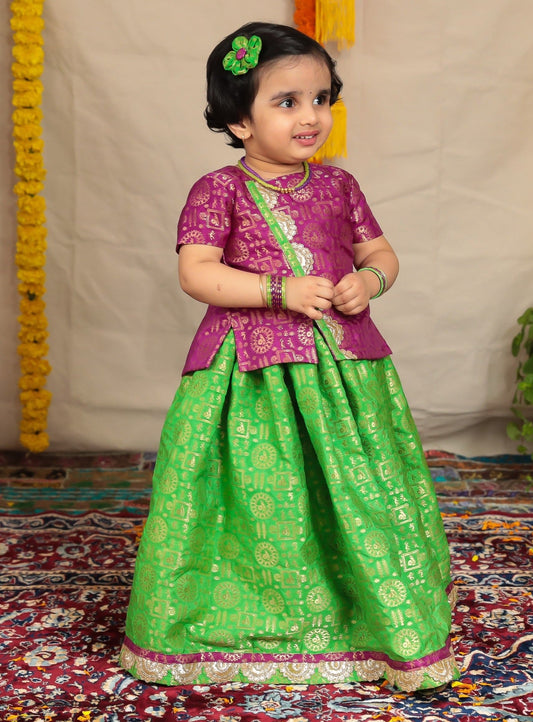 Parrot green brocade parkar and purple highlight teamed with purple brocade overlap pattern polka.Let your princess be as comfortable as in her casuals with carefully designed & crafted Comfort Ethnic Wear by Soyara Ethnics.Keep her fashion quotient high with timeless patterns, vibrant combinations and royal textiles.