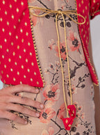 Pastel mauve coloured floral printed tissue kurti with red coloured silk false shrugs for Girls.Let your princess be as comfortable as in her casuals with carefully designed & crafted Comfort Ethnic Wear by Soyara Ethnics.Keep her fashion quotient high with timeless patterns, vibrant combinations and royal textiles.