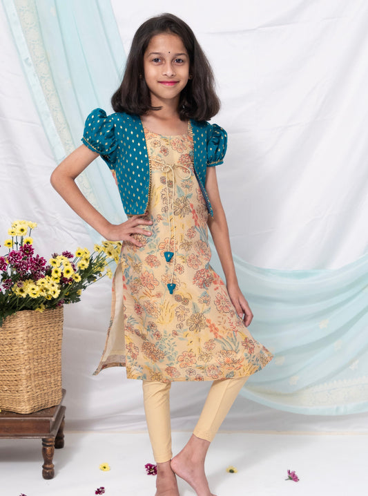 Beige coloured floral printed tissue kurti with teal coloured brocade silk false shrugs for Girls.Let your princess be as comfortable as in her casuals with carefully designed & crafted Comfort Ethnic Wear by Soyara Ethnics.Keep her fashion quotient high with timeless patterns, vibrant combinations and royal textiles.