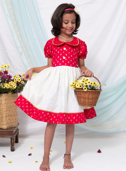 Fuschia brocade silk and Ivory Mysore silk dress with Peter pan collar and puffed sleeves for Girl.Let your princess be as comfortable as in her casuals with carefully designed & crafted Comfort Ethnic Wear by Soyara Ethnics. Keep her fashion quotient high with timeless patterns, vibrant combinations and royal textiles.