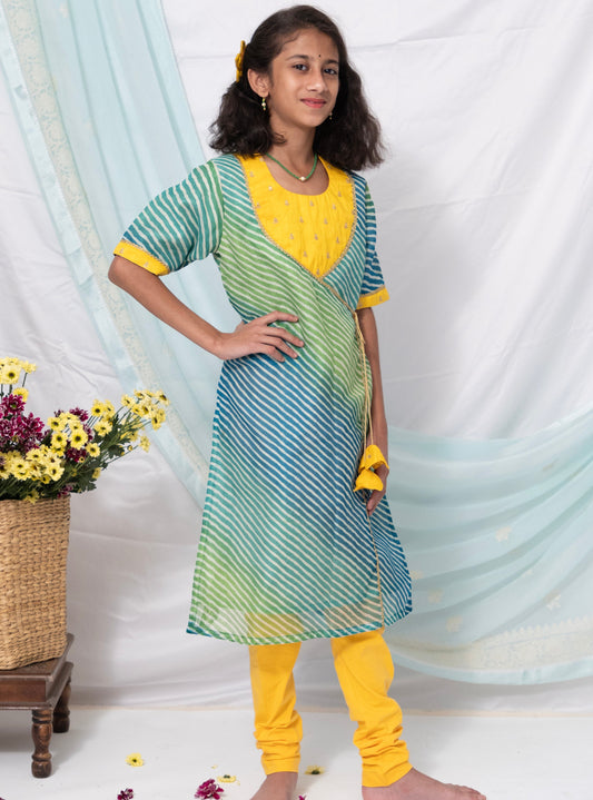 Blue and Green leheriya kotta chanderi kurti with yellow raw silk sequined yoke and flower shaped latkans is the perfect choice for any occasion, especially when paired with yellow leggings . Its elbow length sleeves with yellow highlights add a touch of elegance to the overall look.