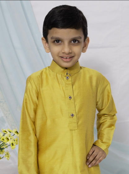 Enhance your traditional ensemble with this Olive yellow cotton silk kurta for Boys. Featuring a stand collar, orange placket detailing, and golden buttons, it can be paired with salwar or jeans for a stylish and comfortable look.