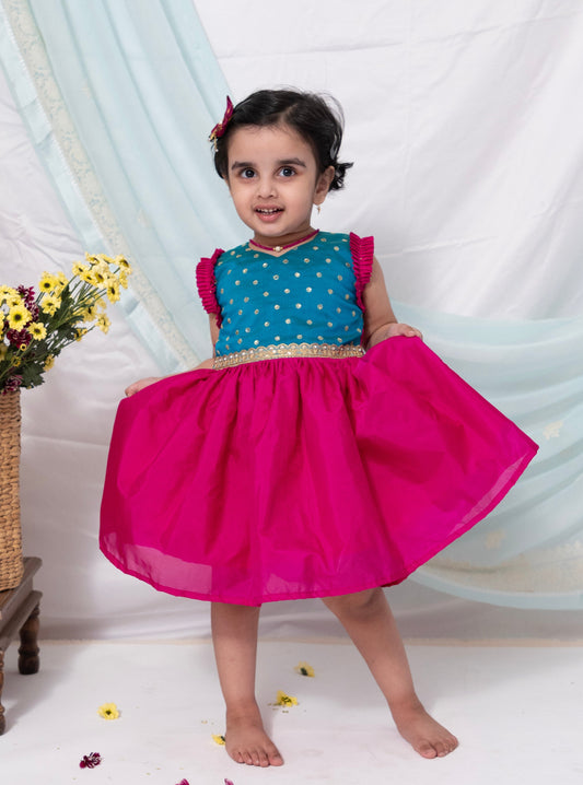 Teal blue sequined bodice with delicate lace embellishment and dark pink silk frock for Girl.Let your princess be as comfortable as in her casuals with carefully designed and crafted Comfort Ethnic Wear by Soyara Ethnics.Keep her fashion quotient high with timeless patterns, vibrant combinations and royal textiles.