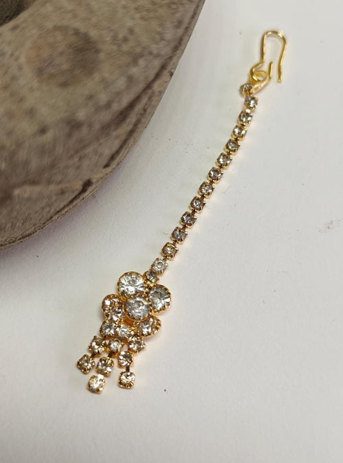 American Diamond Studded golden imitation Flower with danglers shaped metal Maang Tika for Girls.Adorn your princess with head to toe premium quality handcrafted accessories made from allergy free, best quality materials.
