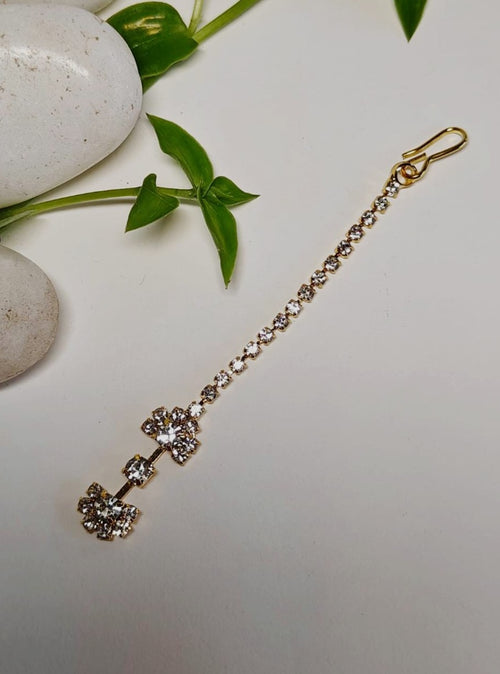 American Diamond Studded golden imitation Half and half flower shaped metal Maang Tika for Girls.Adorn your princess with head to toe premium quality handcrafted accessories made from allergy free, best quality materials.