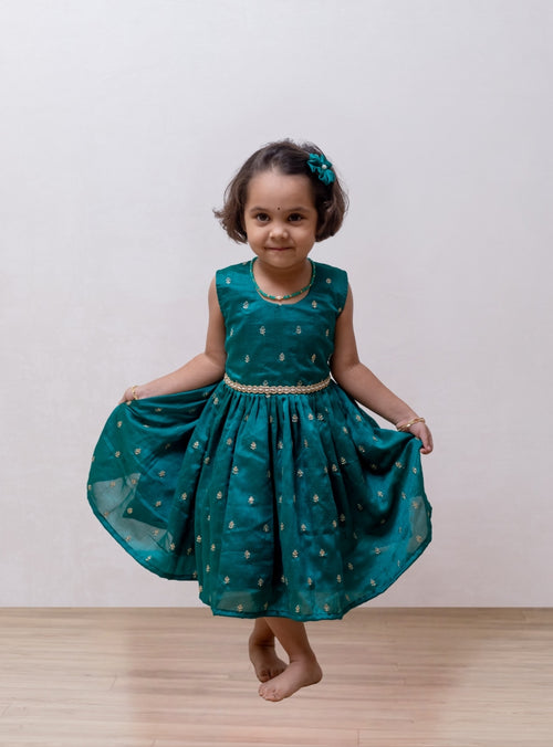 Aqua green Vichitra silk sleeveless dress for Girls.Let your princess be as comfortable as in her casuals with carefully designed and crafted Comfort Ethnic Wear by Soyara Ethnics. Keep her fashion quotient high with timeless patterns, vibrant combinations and royal textiles.
