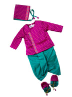 This Sharad Kurta and dhoti ensemble for baby boys features a soft brocade silk front-open kurta adorned with contrasting lace details, paired with a vibrant aqua green pooja silk dhoti. The set is completed with a matching bonnet and booties, offering a coordinated and elegant traditional outfit.