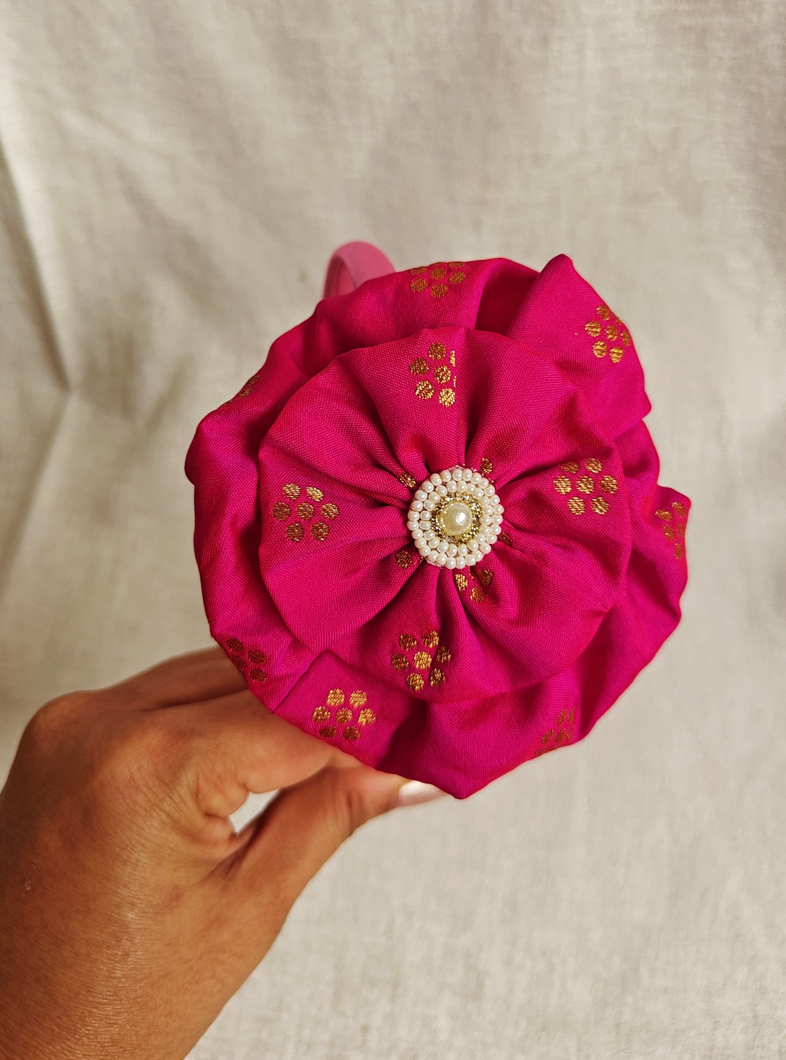 This Dark pink Big Handcrafted fabric flower headband with pearls embellishment for Girls is expertly crafted with immense love and suitable for girls above the age of 2 years. The intricate handwork and delicate pearl detailing make it a standout accessory for any young girl.