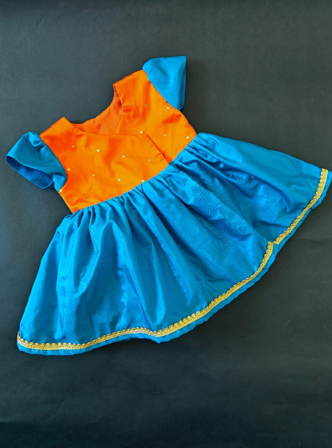 Orange brocade & teal blue silk front open dress for new born Baby Girl provides max comfort. It's the perfect outfit for your baby's naming ceremony , naamkaran or annaprashan ceremony. Traditional and ethnic dress for Noolukettu Ceremony, Paachvi Puja, Cradle ceremony,Rice Ceremony,Chatti Puja etc. Apt gifting idea. 