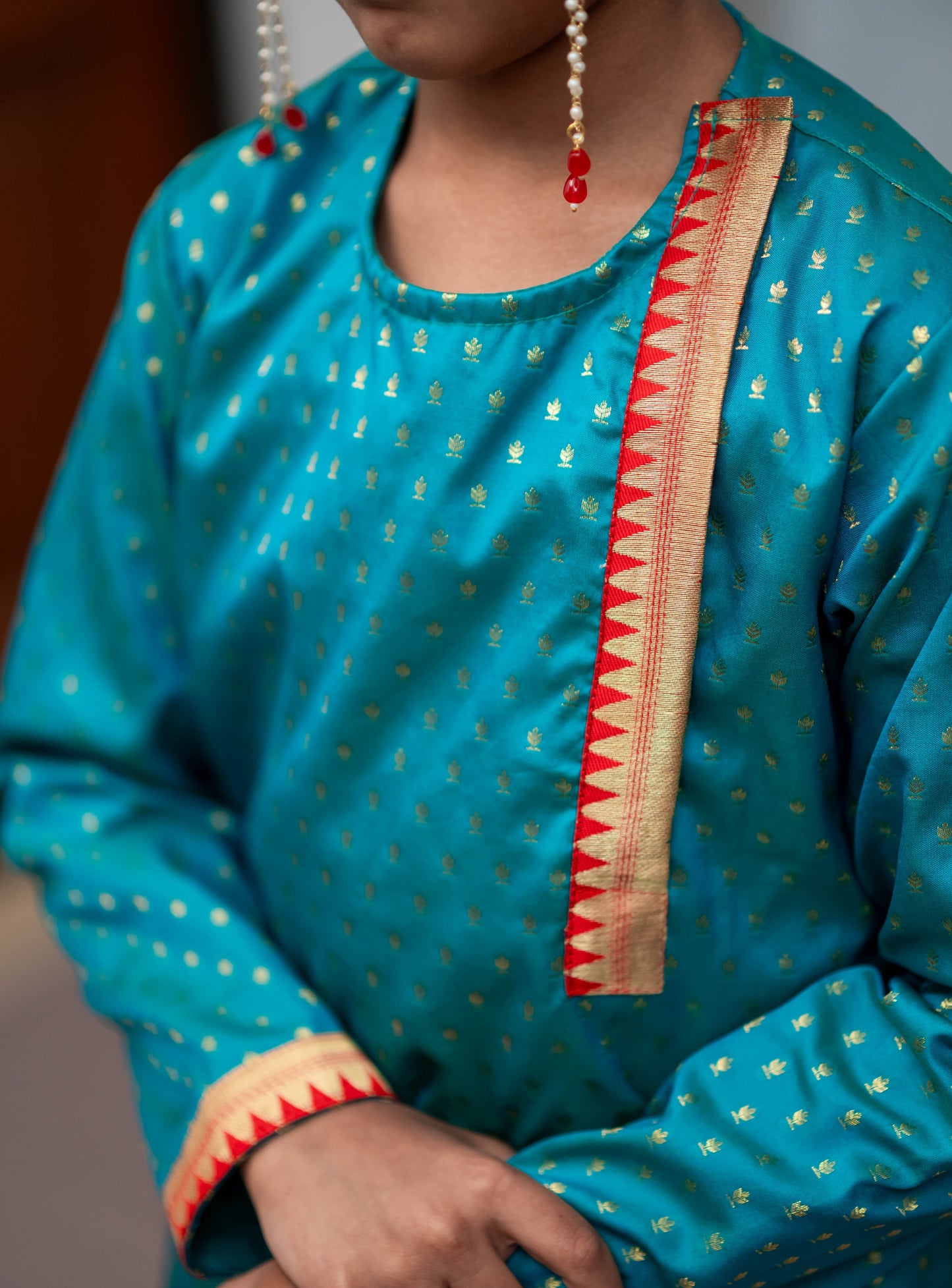 Peacock green brocade silk side placket round neck short kurta with temple border highlights on placket and cuffs for Batu.Kurta is 
ideal for rituals like Matrubhojan,Muhurt during Munj/Upanayan/Vratabandha/Thread Ceremony.