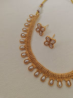 Pearls studded choker with matching earrings for Girls.This set includes a choker and matching earrings with studded pearls, perfect for girls. The drawstring allows for easy length adjustment.