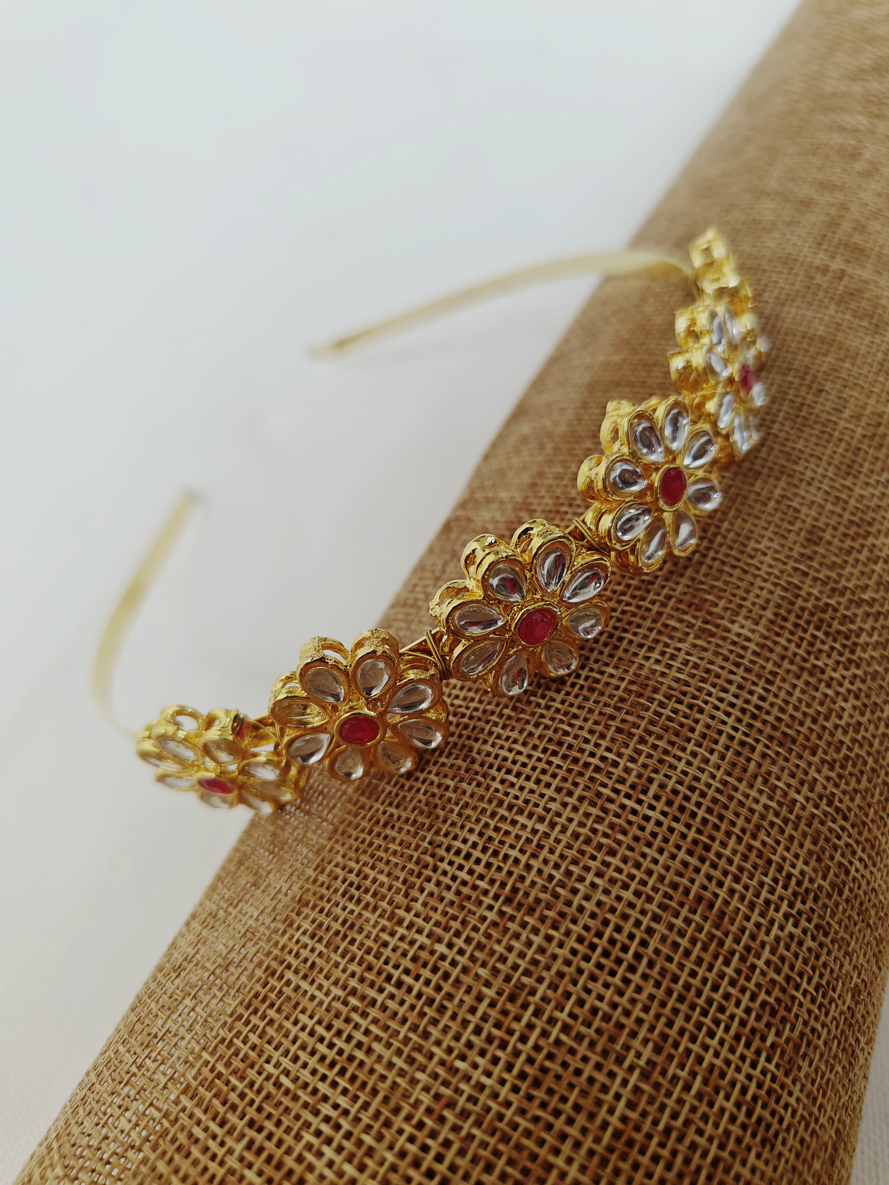 Kundan studded flower and leaves motifs mathapatti headband in golden metal for Girls.Adorn your princess with head to toe premium quality handcrafted accessories made from allergy free, best quality materials.