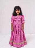 This Lilac banaras brocade ghagra is complemented by a Peterpan collared mutton sleeved choli.Let your princess be as comfortable as in her casuals with carefully designed & crafted Comfort Ethnic Wear by Soyara Ethnics.Keep her fashion quotient high with timeless patterns, vibrant combinations and royal textiles.