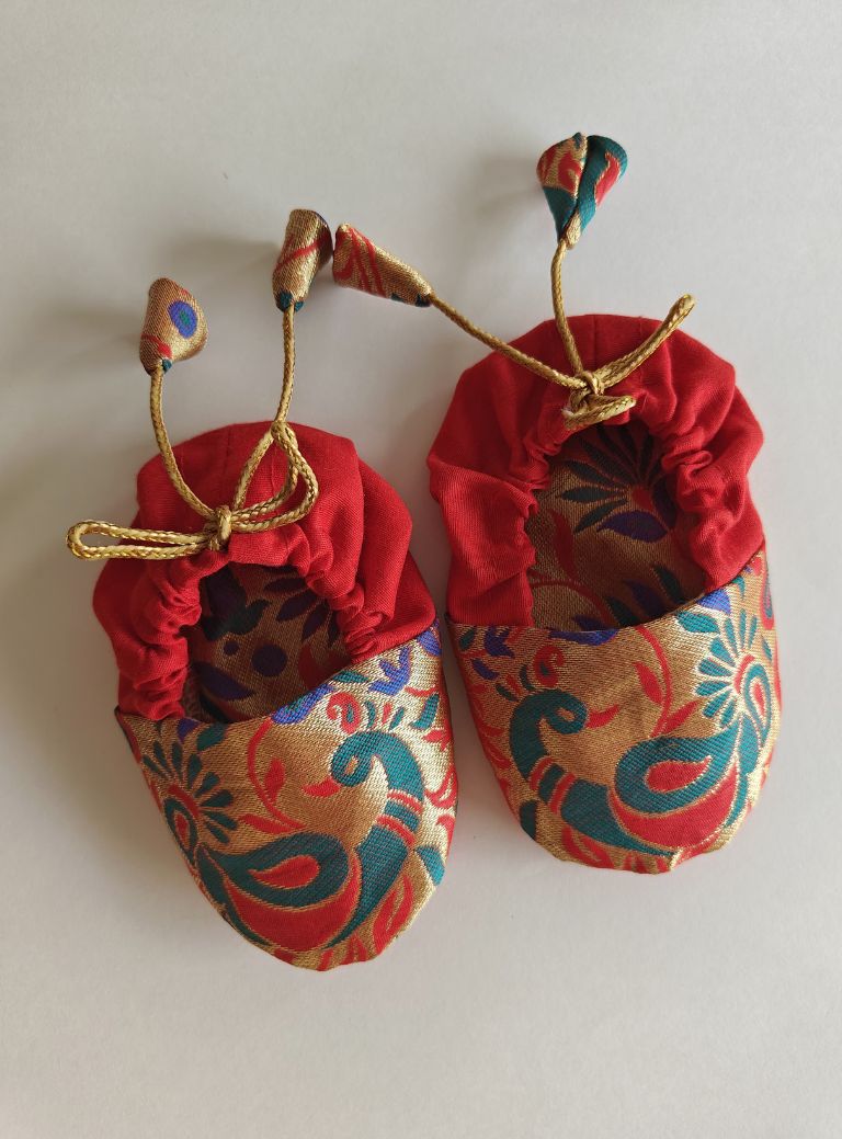 red Peacock Paithani Motif, adjustable unisex Newborn Baby Mojaris /Booties.Paithani motif unisex booties for baby. Team these with any ethnic dress and complete the royal look! Completely made out of fabrics inside out , make these booties perfectly comfy first ethnic wear for the newborn.
