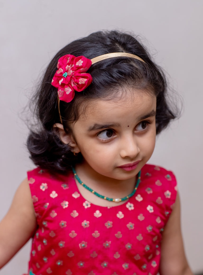 Deep pink brocade silk sleeveless flared dress with turquoise coloured sequined border for Girls