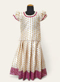 Featuring a white brocade satin silk parkar polka, with a heavy banarasi border and elegant lace accents around the neck and arms.