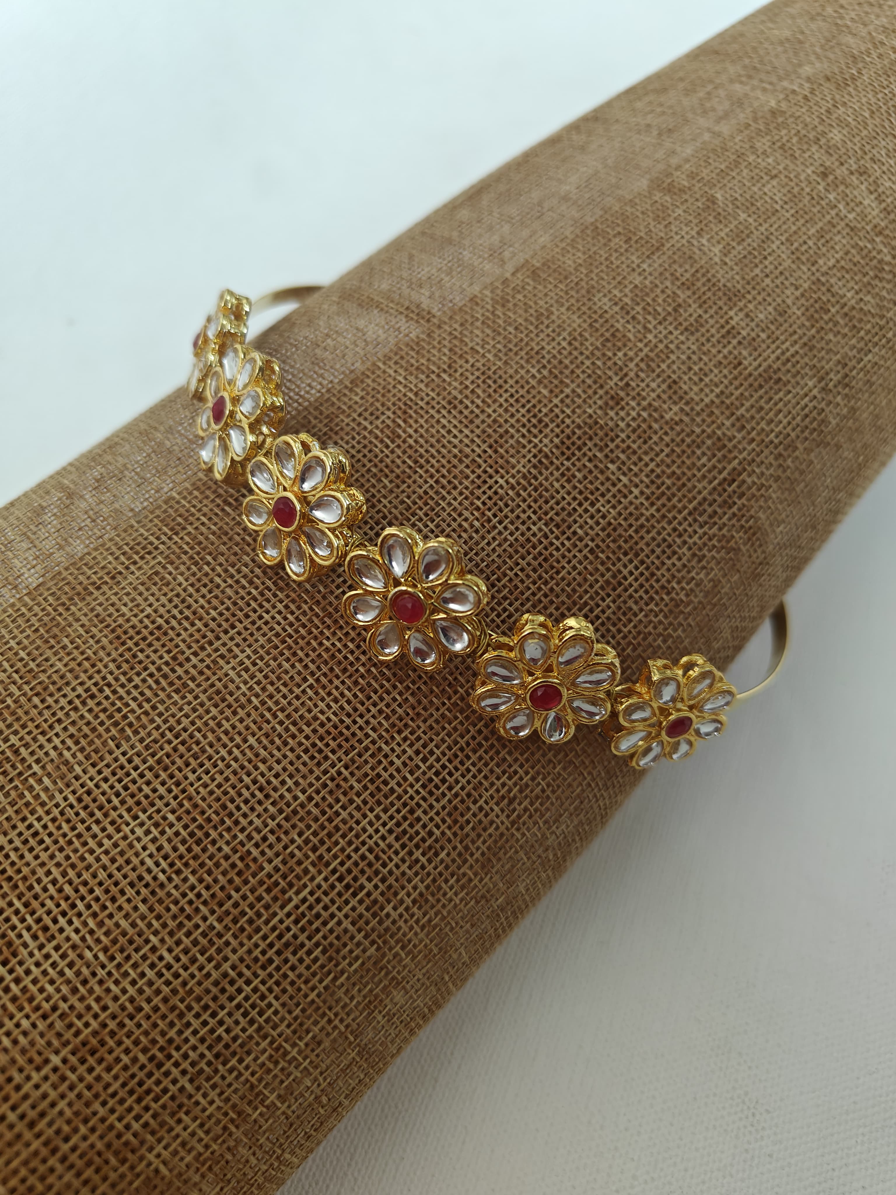 Kundan studded flower and leaves motifs mathapatti headband in golden metal for Girls.Adorn your princess with head to toe premium quality handcrafted accessories made from allergy free, best quality materials.