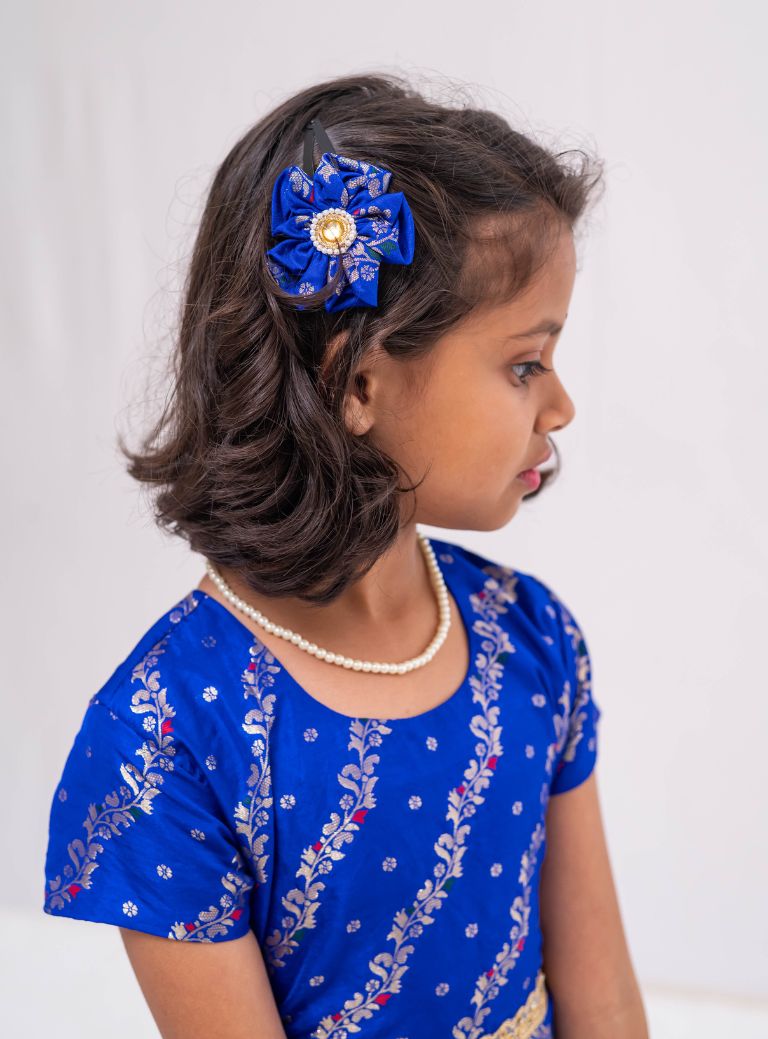 Ink blue banaras satin brocade silk gown with cap sleeves and ruffled flare for Girls.Let your princess be as comfortable as in her casuals with carefully designed & crafted Comfort Ethnic Wear by Soyara Ethnics.Keep her fashion quotient high with timeless patterns, vibrant combinations and royal textiles.
