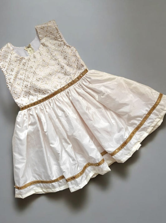 Ivory mysore silk flared dress with machine embroidered and sequined bodice. Embellished waist and flare with golden lace . Ideal for Bhikshaval&nbsp;