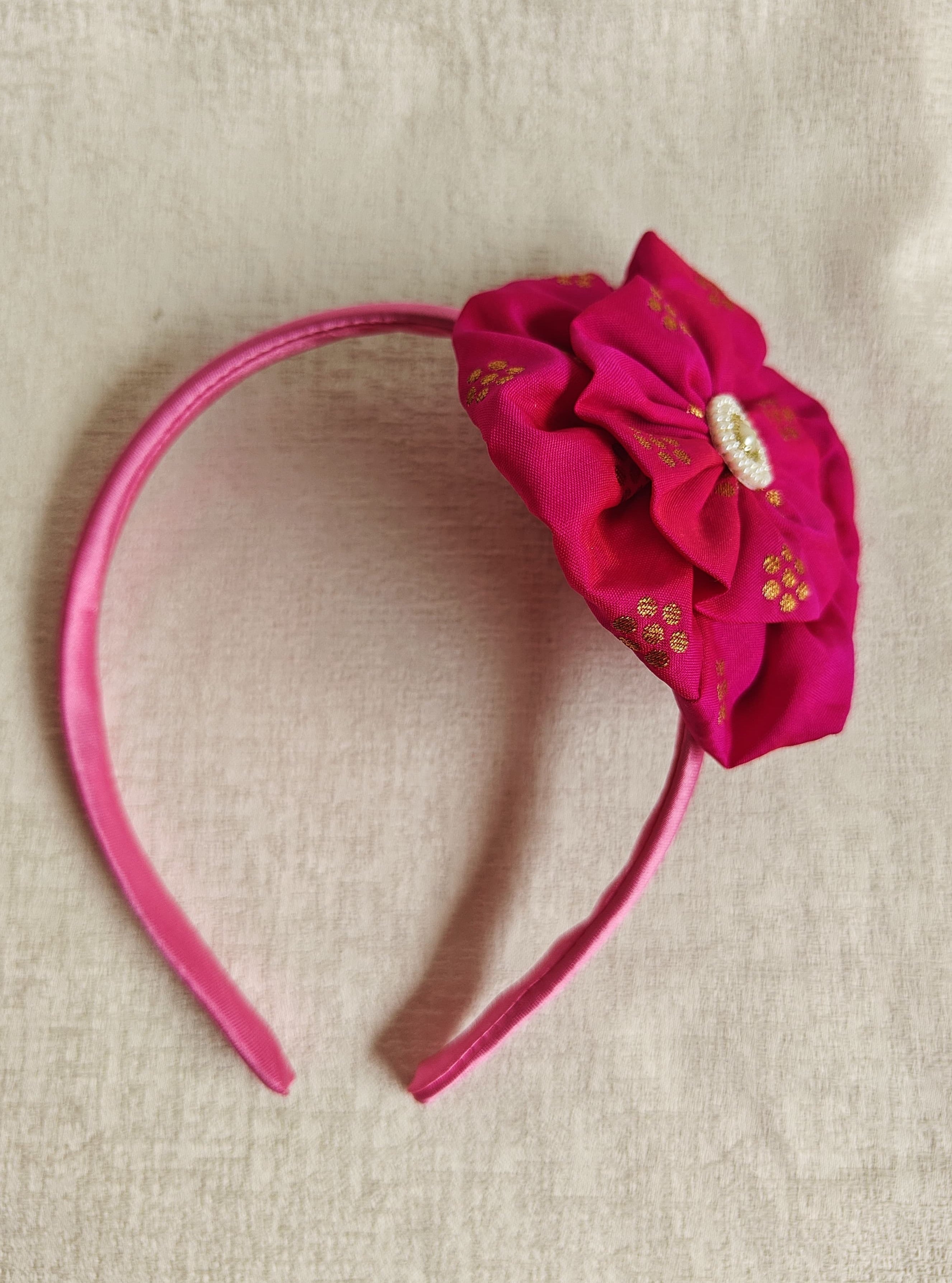 This Dark pink Big Handcrafted fabric flower headband with pearls embellishment for Girls is expertly crafted with immense love and suitable for girls above the age of 2 years. The intricate handwork and delicate pearl detailing make it a standout accessory for any young girl.