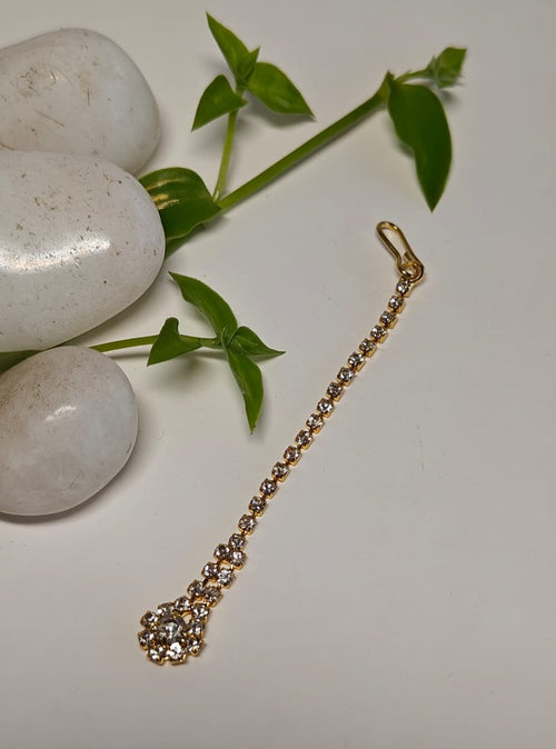 American Diamond Studded golden imitation Flower shaped metal Maang Tika for Girls.Adorn your princess with head to toe premium quality handcrafted accessories made from allergy free, best quality materials.