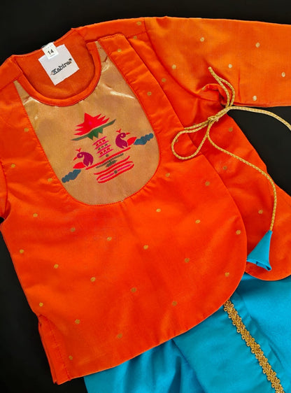 Orange brocade Angrakha kurta with Peacock Paithani yoke teamed with contrast teal blue dhoti for newborn baby boy.It's the perfect outfit for your baby's naming ceremony,naamkaran,annaprashan ceremony.Traditional dress for Noolukettu Ceremony,Pachavi Puja,cradle ceremony,Rice Ceremony,Chatti Puja etc. Apt gifting idea