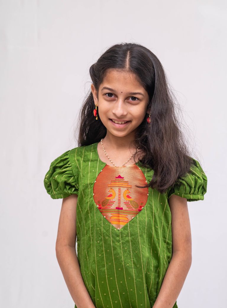 Olive green satin chanderi sequined, puff sleeved kurti with paithani yoke pattern for Girls.Let your princess be as comfortable as in her casuals with carefully designed & crafted Comfort Ethnic Wear by Soyara Ethnics.Keep her fashion quotient high with timeless patterns, vibrant combinations and royal textiles.