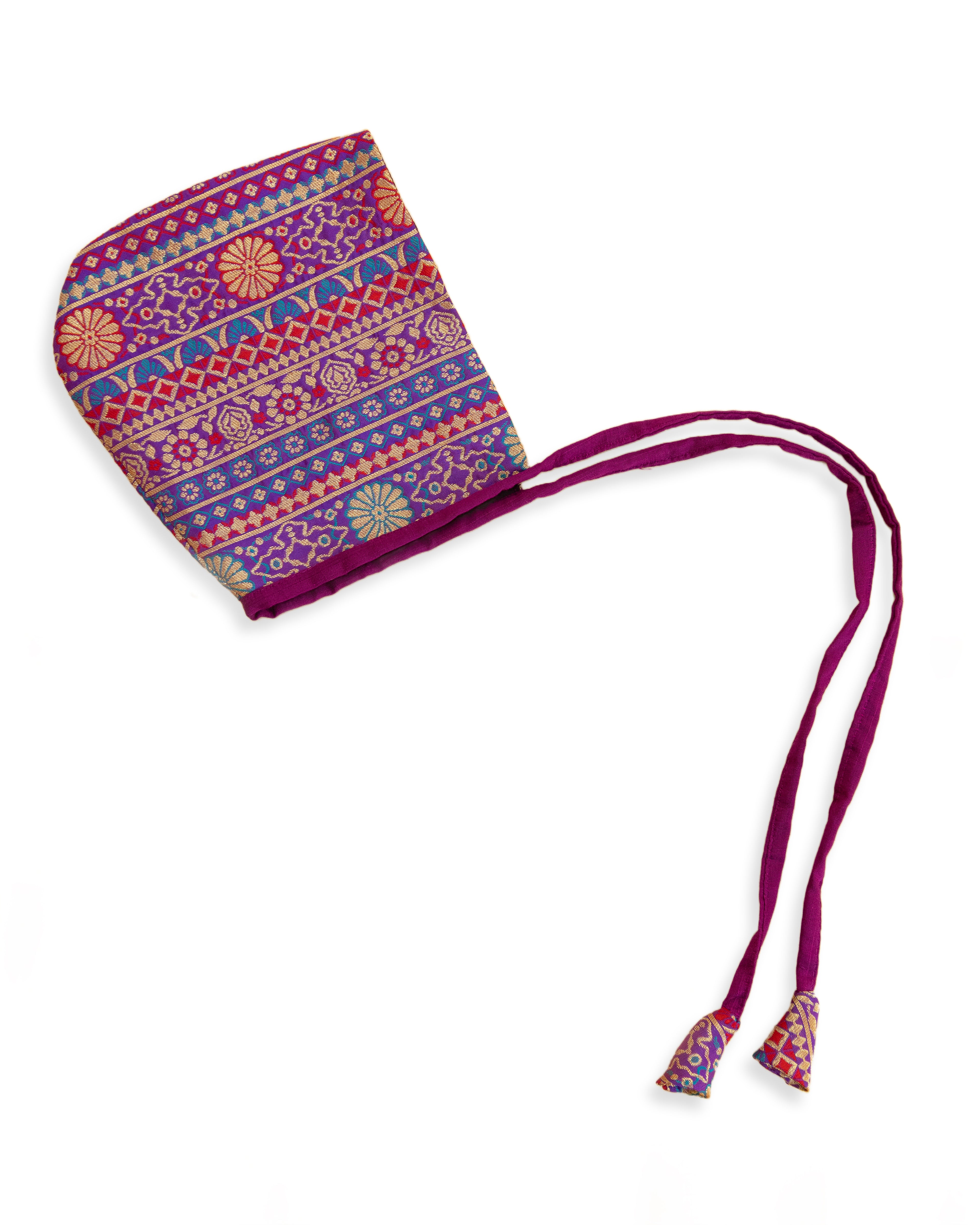 Purple Premium Banarasi Brocade Bonnet &nbsp;/ Topade / Topi/ Baby Cap for New Born. A baby bonnet is a charming and timeless accessory designed to protect a baby's head. This Golden Banaras Brocade SIlk Brocade is a generic addition your newborn baby's wardrobe which can be teamed with any traditional attire.&nbsp;&nbsp;