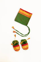 Green handloom khunn with red border topda / topi/ bonnet with coordinated khunn booties set for NewBorn. Handcrafted accessories for Newborn are perfect add ons to any traditional attire of the baby.Designer baby mats,set of generic bloomers are other naming ceremony essentials.