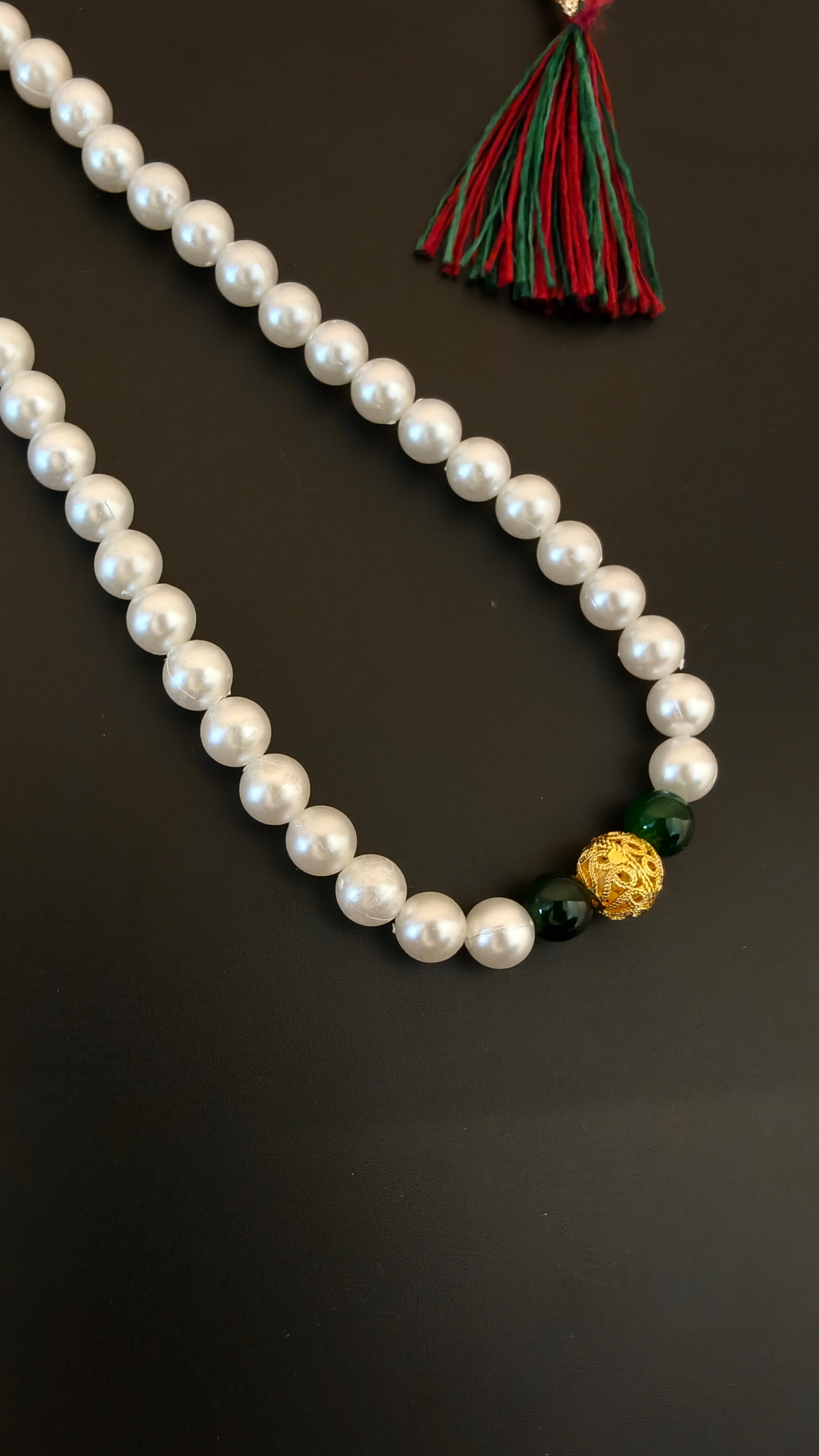 Pearls mala with a golden filigree pendant with green glass beads for a baby boy
