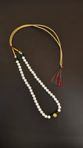 Pearls mala with a golden filigree pendant with green glass beads for a baby boy