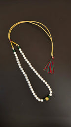 Pearls mala with a golden filigree pendant with green glass beads for a baby boy