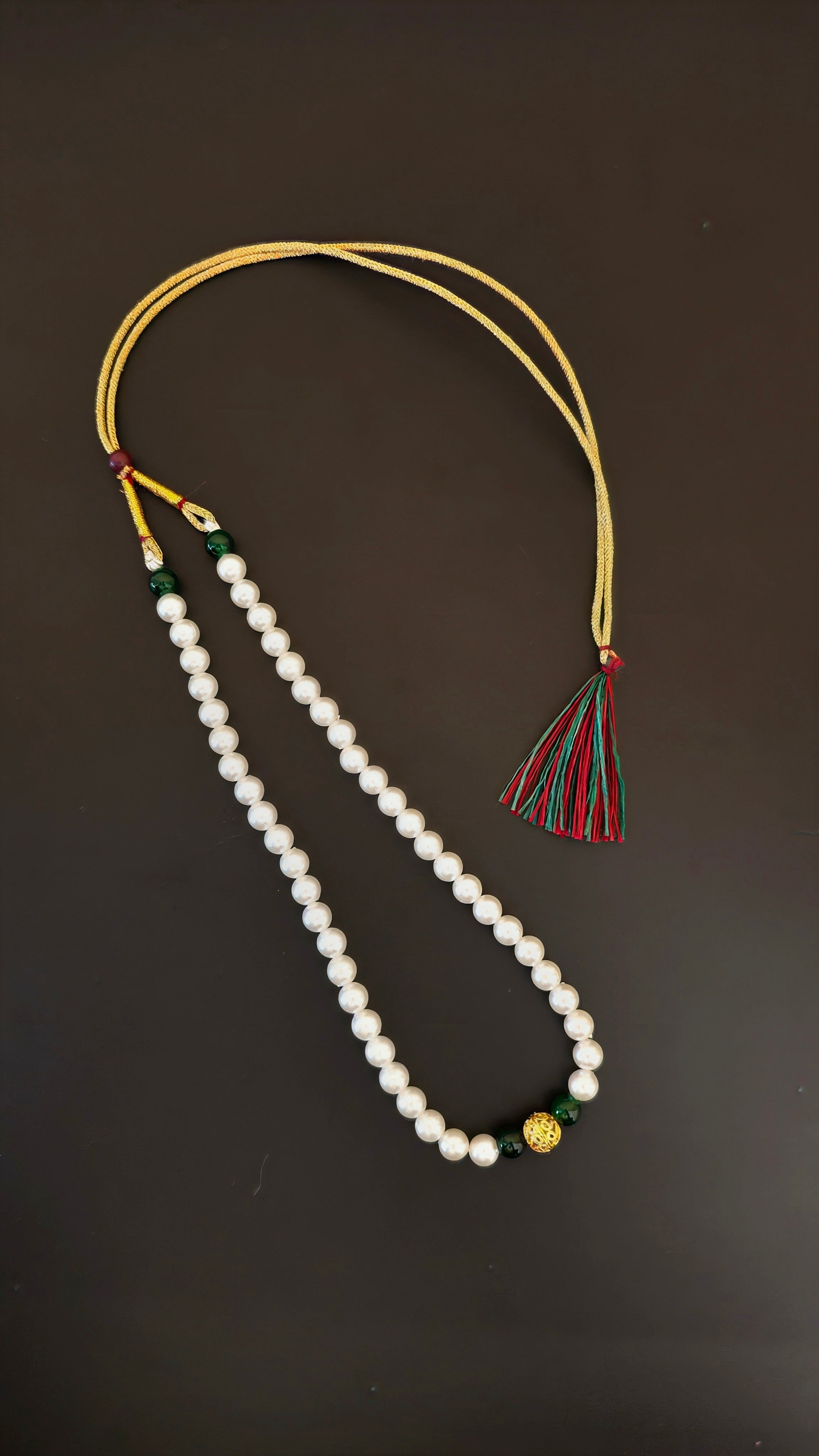 Pearls mala with a golden filigree pendant with green glass beads for a baby boy