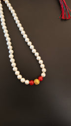 Pearls mala with a golden filigree pendant with red glass beads for a baby boy